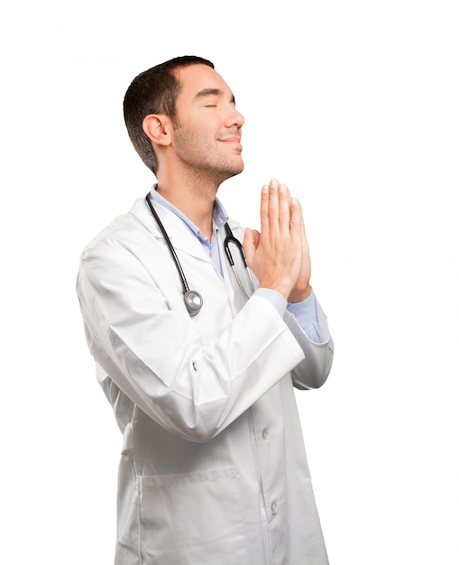 Hopeful young doctor praying