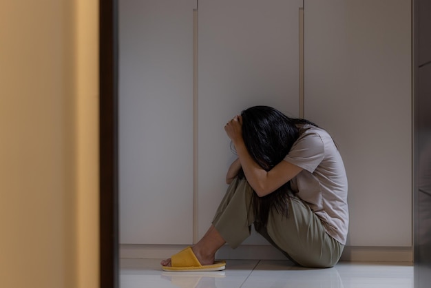 Hopeless woman sit on floor and feel so sad