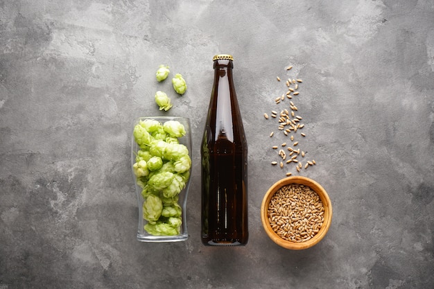 Hops and barley with beer, flat lay.