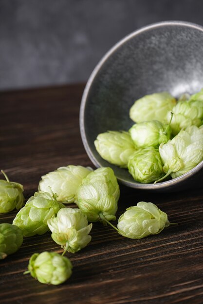 Hops in a bowl on a wooden space. Close-up.