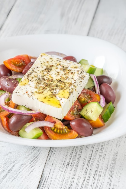 Horiatiki Greek salad with feta cheese in the bowl