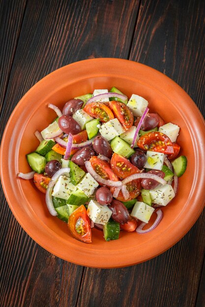 Horiatiki Greek salad with feta cheese in the bowl