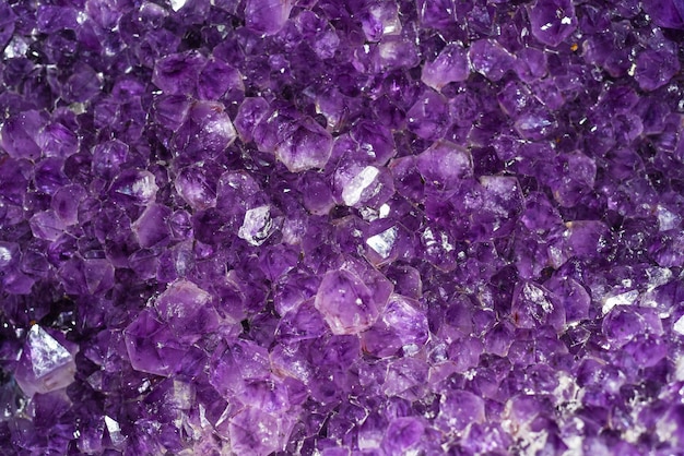 Horisontal background made of amethyst mineral close up