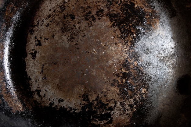 Horizontal bottom of heavily used lubricated iron skillet texture