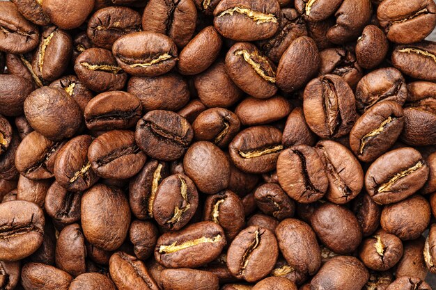 Horizontal closeup on brown coffee beans texture pattern background