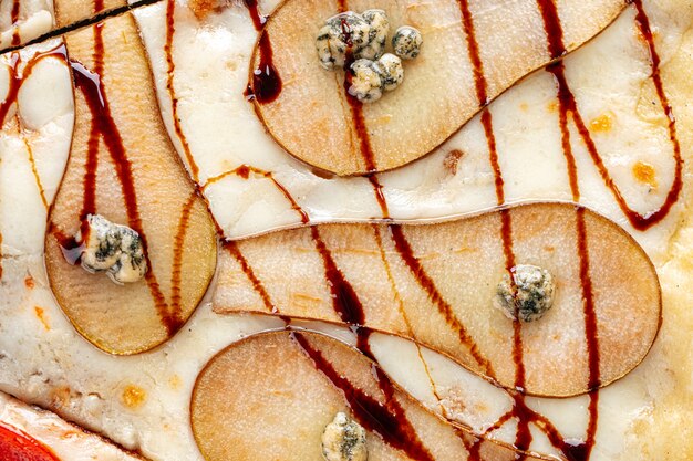 Horizontal closeup on pear and cheese pizza texture