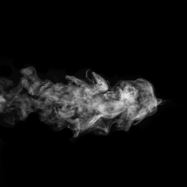 Photo horizontal curly white steam, fog or smoke isolated with transparent effect on black surface.