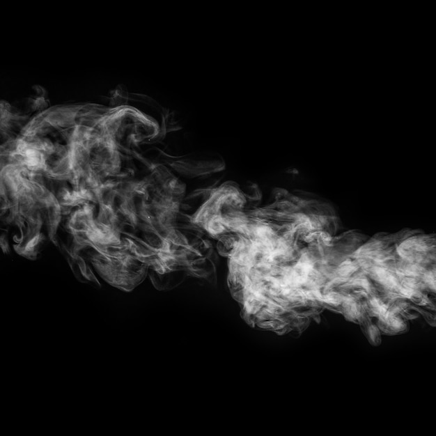 Horizontal curly white steam, fog or smoke isolated with transparent effect on black surface.