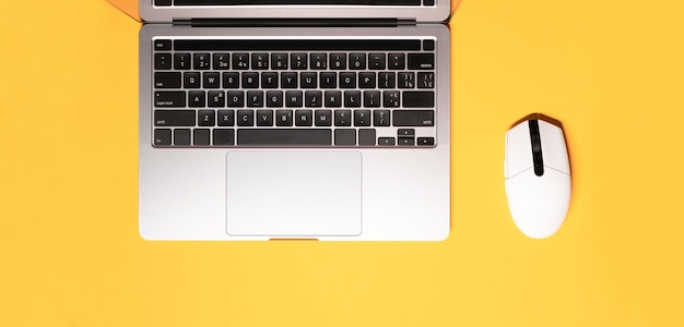 Horizontal flat lay minimalist photo with a silver grey laptop computer