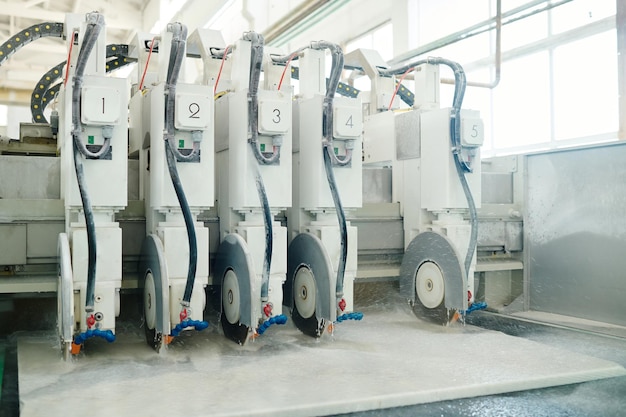 Horizontal image of big machine with sharp discs for cutting marble in factory of cutting stone