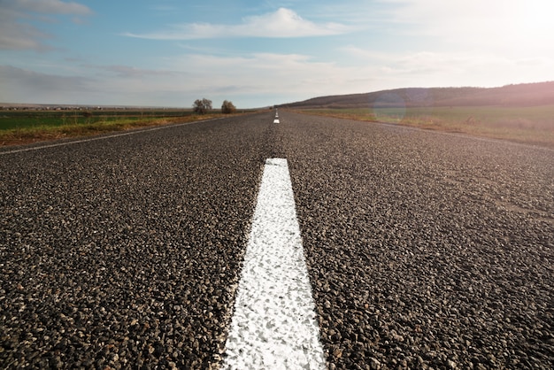 Horizontal image of a long straight empty highway