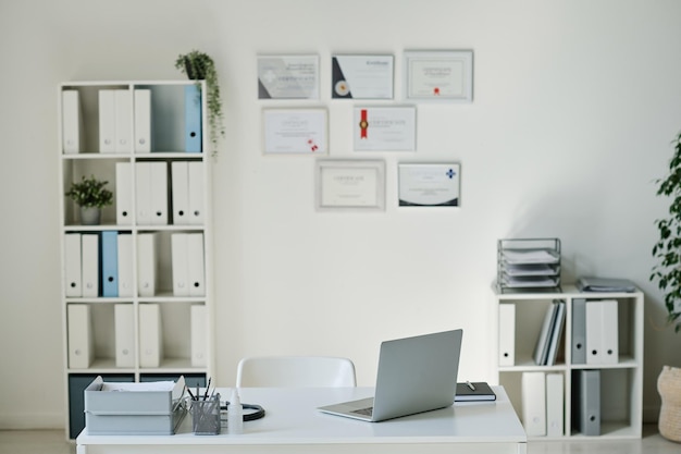 Horizontal image of modern medical office of doctor with workplace with laptop