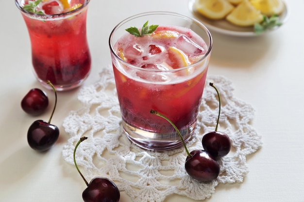 Horizontal photo of homemade cherry lemonade in glasses 