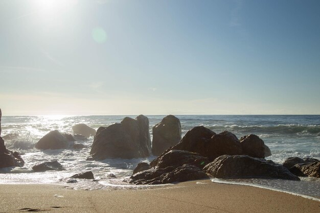 Horizontal photos, with stones near the sea in Paraia Senhora da Hora in Portugal