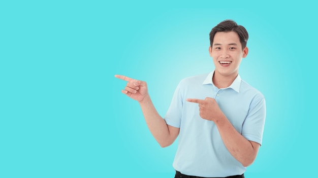 Horizontal portrait image of happy young man in studio over light blue background