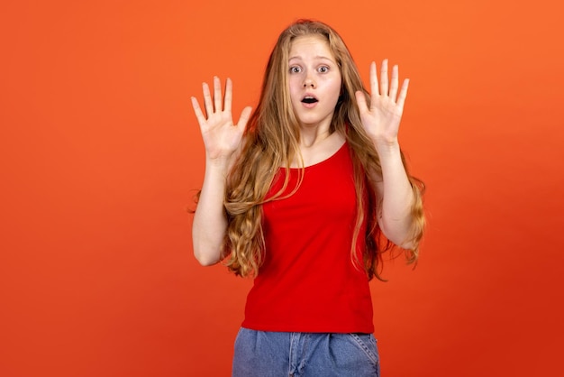 Horizontal portrait of young scared girl isolated on red studio background concept of human