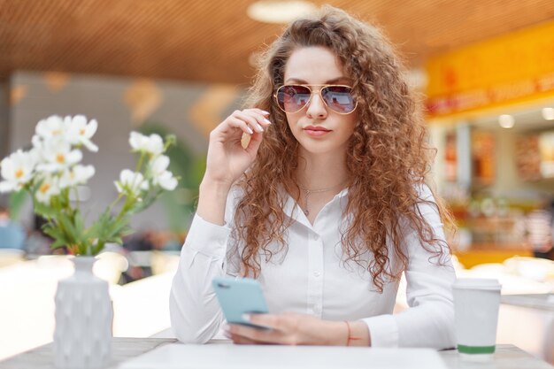 Horizontal shot of beautiful curly woman with confident look