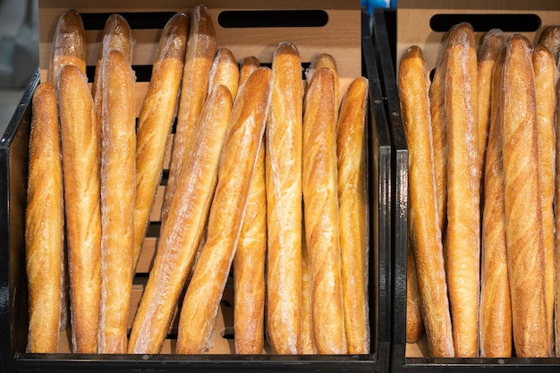 Horizontal shot of fresh warm baguettes set out in modern grocery store, copy space