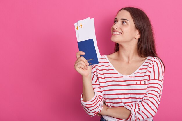 Horizontal shot of modern trendy smiling woman wearing striped shirt