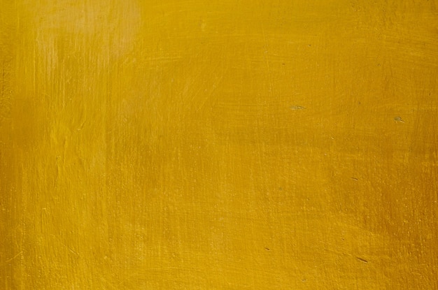 ゴールド漆喰壁の背景の水平方向のテクスチャ