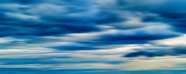 Horizontal vivid blue cloudscape dramatic clouds abstraction background backdrop