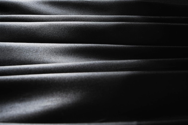 Horizontale lijnen van zijdestof zwarte abstracte achtergrond van satijnstof