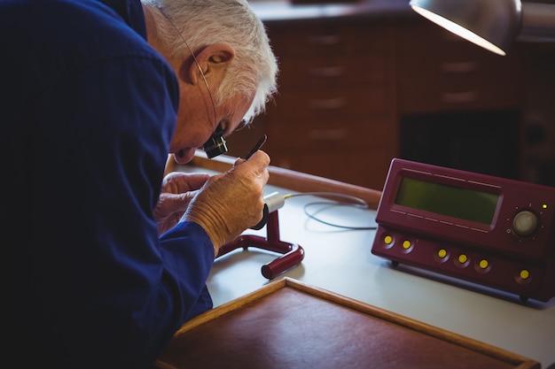 Horologist repairing a watch