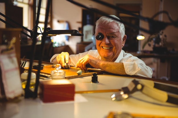 Horoloog repareren van een horloge in de werkplaats