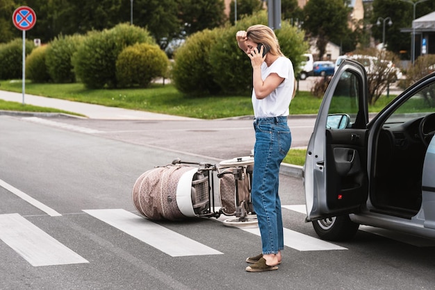 Photo horrified driver makes an emergency call after a car accident with baby pram on the crosswalk