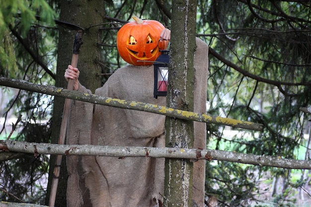 Horror pumpkin with a scythe