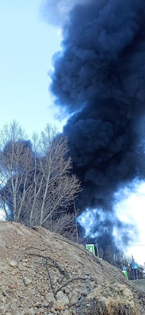 Horrors of war in Ukraine Black smoke against sky Fire during the war Disaster