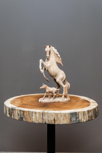 A horse sculpture on a table with a dog on it