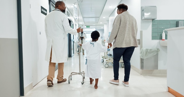 Hospital child and doctor while walking medical and checkup with drip healthcare and medicine Hospitalisation patient and care with help treatment and diagnosis for health wellness and virus