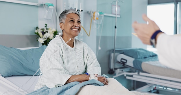 hospital doctor and woman consulting with good news with ventilation tube for oxygen medical service and care healthcare happy and mature person smile for surgery recovery wellness and results