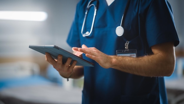 hospital ward unrecognizable head nurse doctor surgeon uses digital tablet computer health care vitals monitoring computer machine modern clinic with advanced equipment and professional working