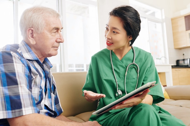 Hospital worker visiting senior patient at home