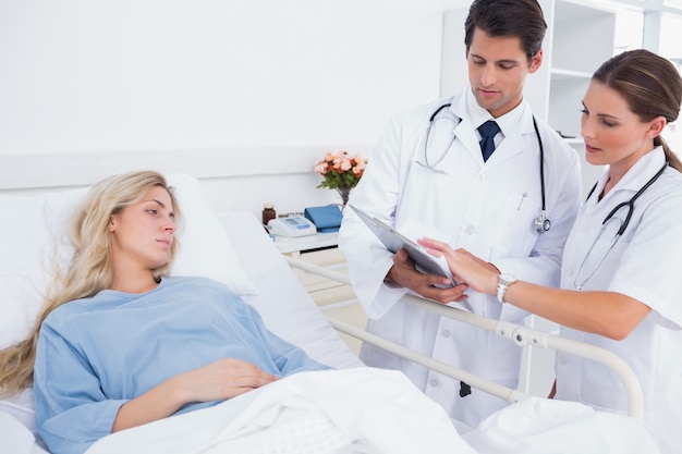 Hospitalized woman and doctors