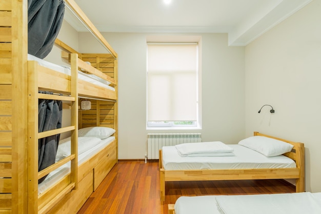 Photo hostel dormitory beds arranged in room