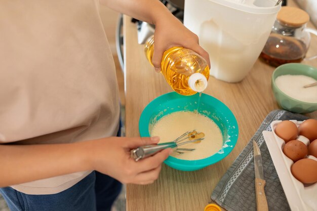 Photo the hostess adds butter to the pancake batter