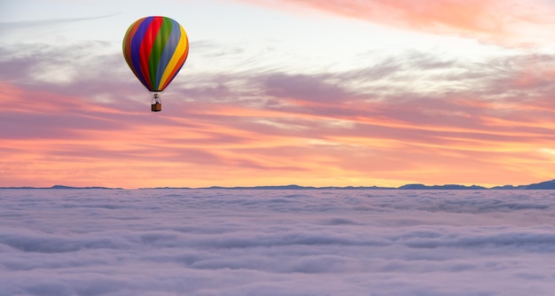 Hot Air Balloon flying over Canadian Nature Landscape on the Pacific West Coast over the clouds