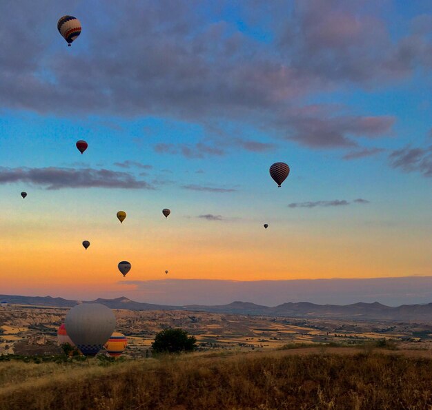 Photo hot air balloon flying over landscape against sky