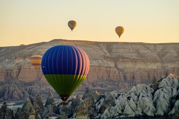 Hot air balloon flying over rock landscape at Cappadocia Turkey