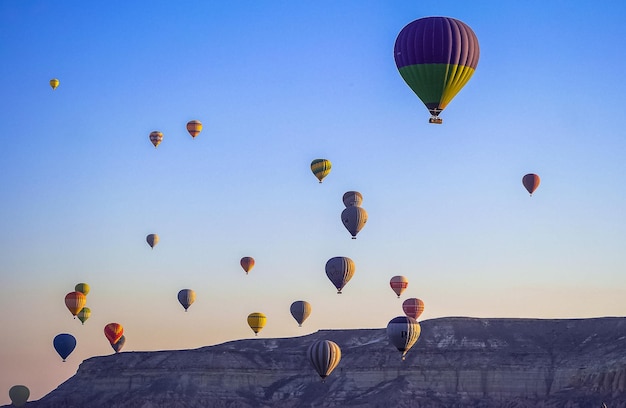 Hot air balloon flying over rock landscape at Cappadocia Turkey