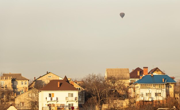 Hot air balloon flying over the villas
