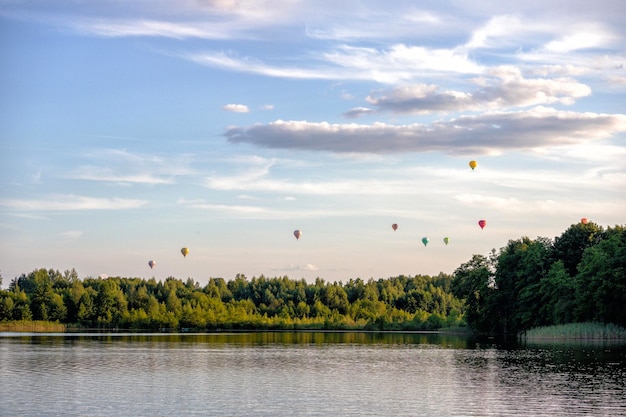 hot air balloons flying over a lake