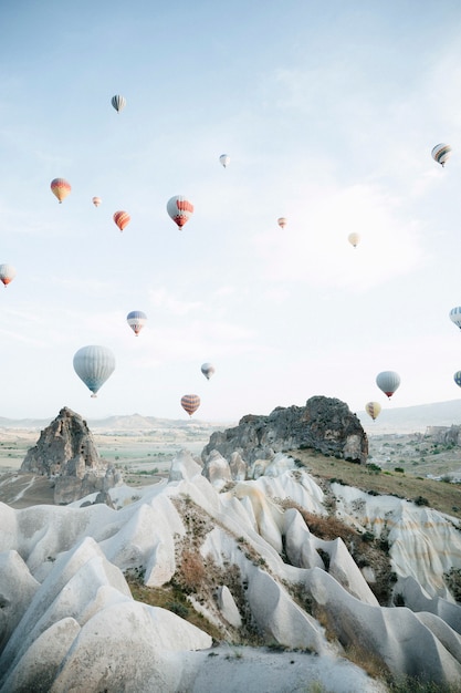 Hot air balloons landing in a mountain Cappadocia Goreme National Park Turkey.