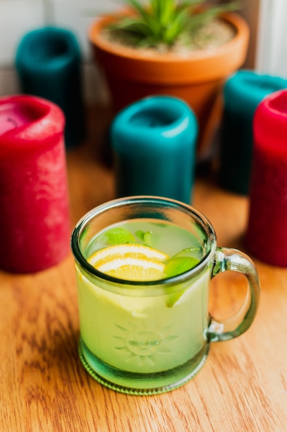 hot alcoholic drink with mint and lemon in a glass mug