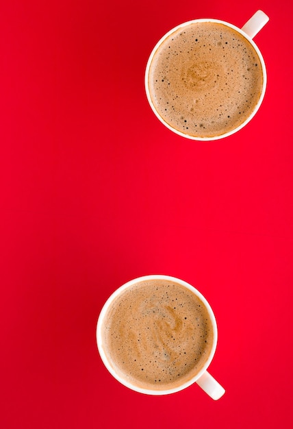 Hot aromatic coffee on red background flatlay