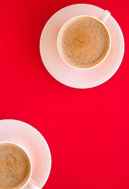 Hot aromatic coffee on red background flatlay