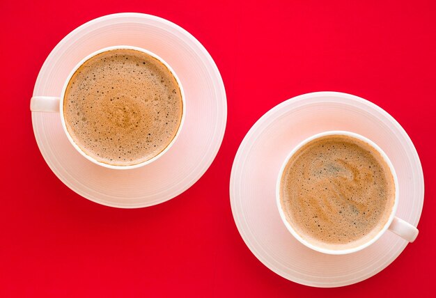 Hot aromatic coffee on red background flatlay